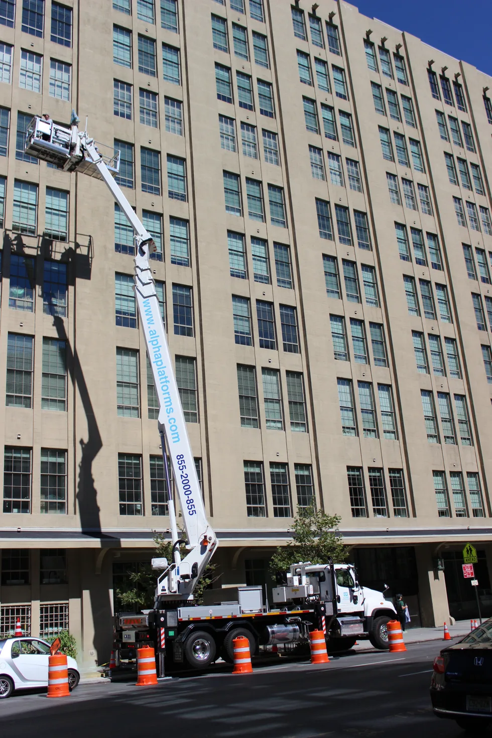 Aerial work platforms beside a multi-storey building